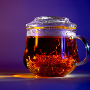 caffeine-free energy drink for calm focus, a glass mug of golden saffron drink