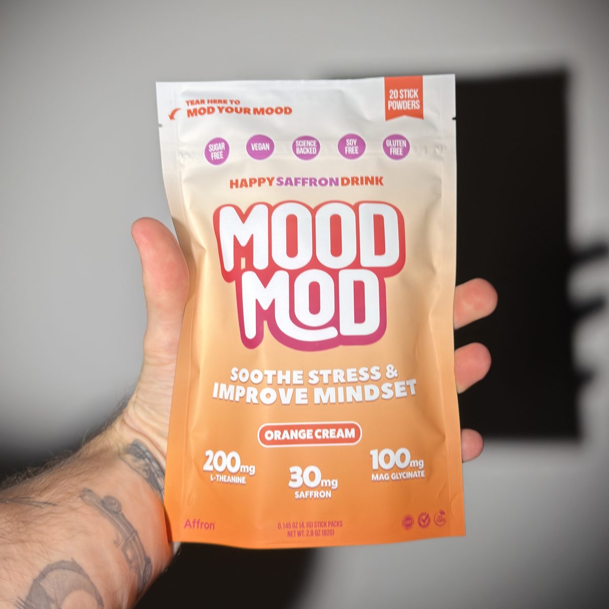 Mood Mod Orange Cream pouch held in hand, 20 saffron drink stick packs for stress and mood support