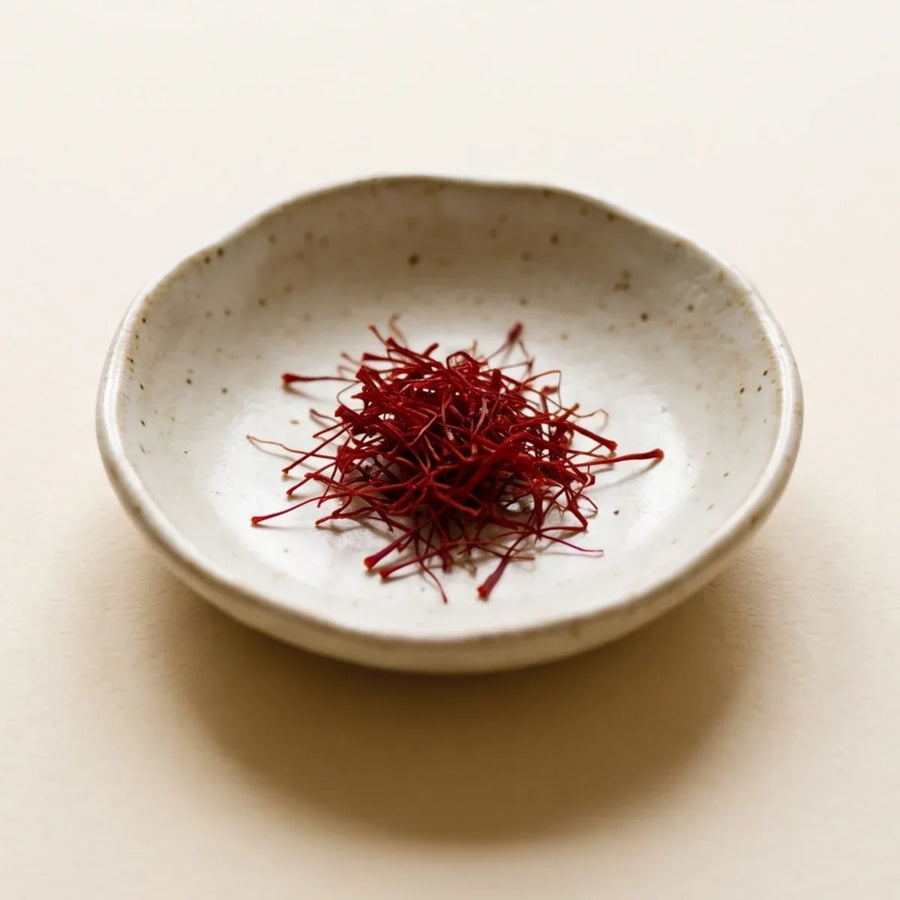 Saffron threads in a small ceramic dish, a natural extract studied for reducing anxiety and low mood