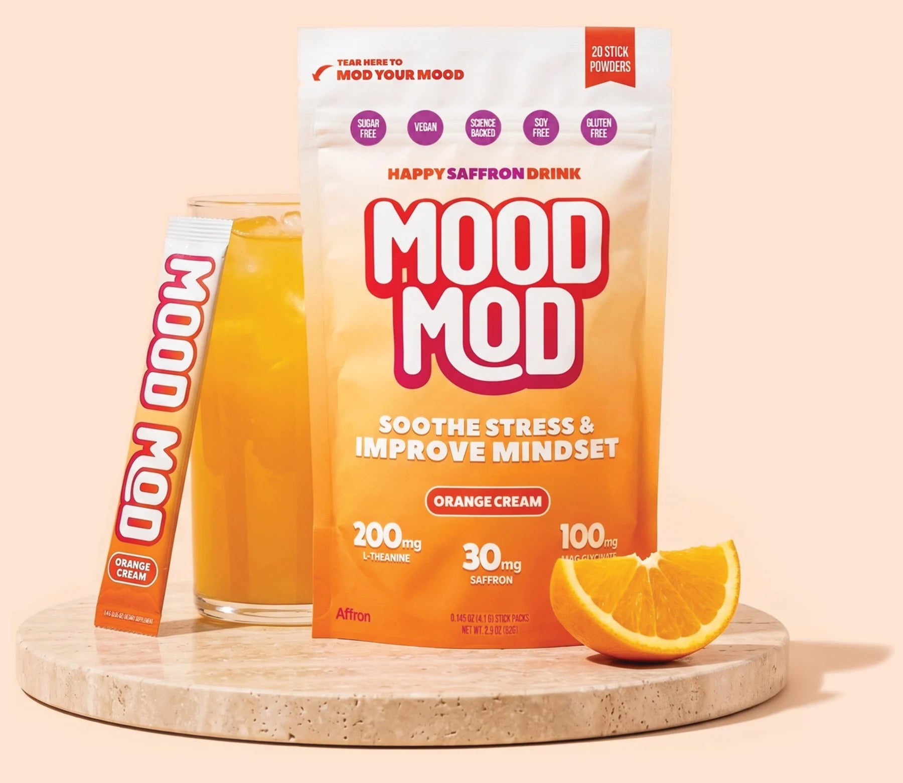 Mood Mod saffron orange cream drink mix, prepared glass and stick pack for calm and natural stress relief.