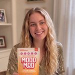 Tricia M., verified Mood Mod customer, holding a Mood Mod pouch